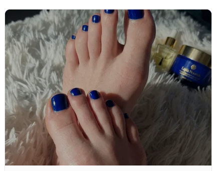 Natural foot content with blue nail polish and lotion