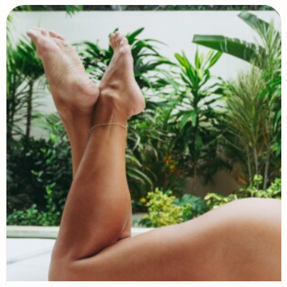 Barefoot lifestyle photo — feet resting on a sofa